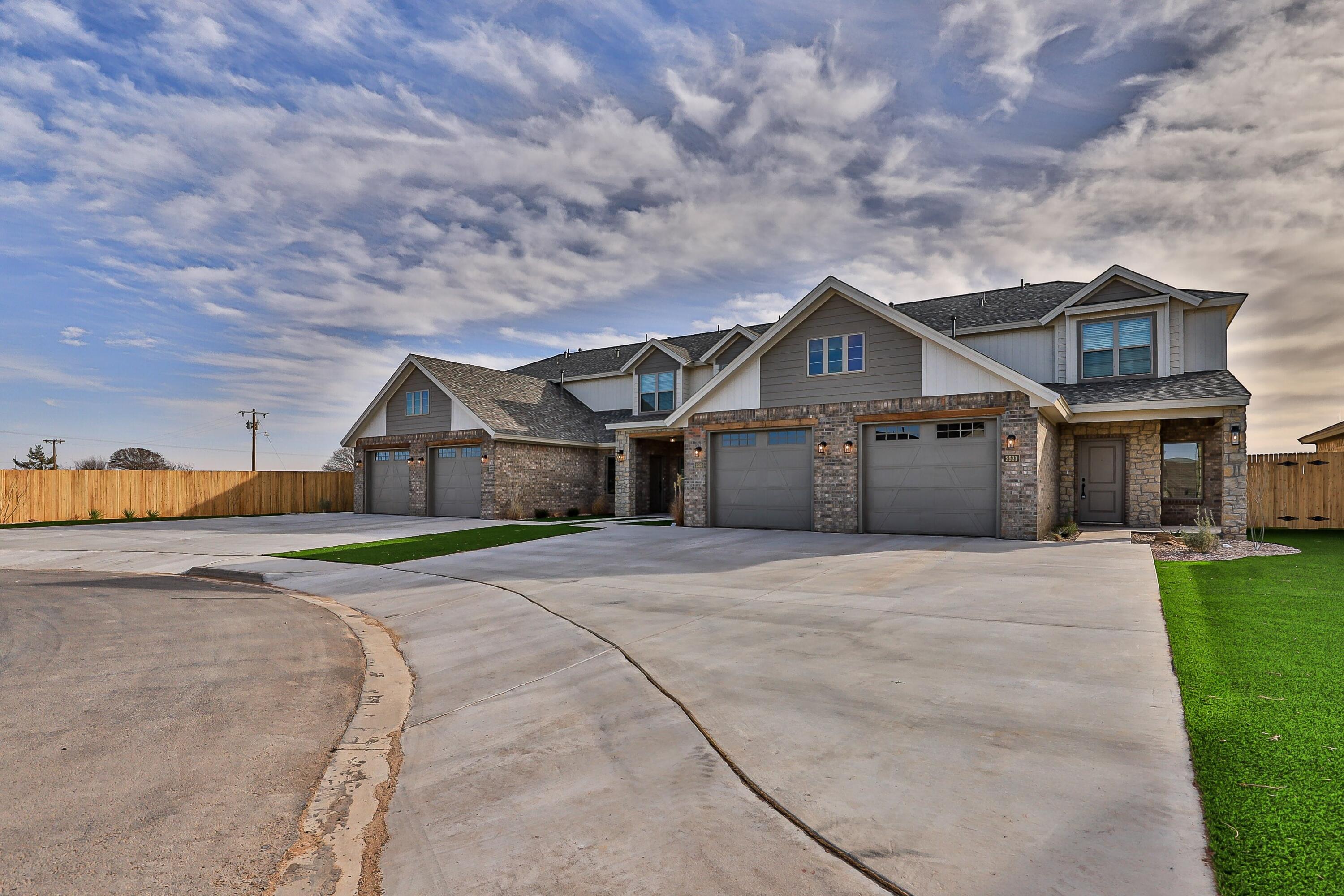 2529 138th Street Lubbock, TX 79423 - Photo 2 of 24 a front view of a house with a yard and garage