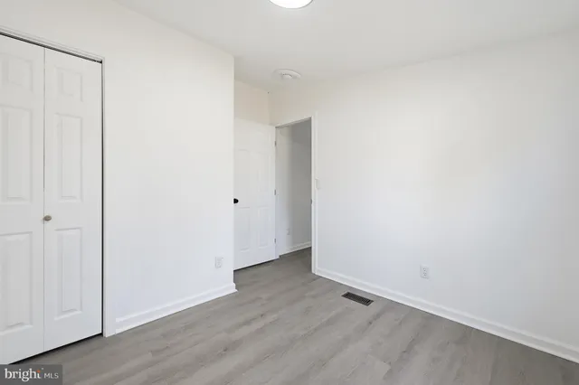 an empty room with wooden floor