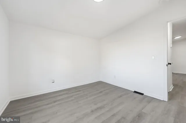 an empty room with wooden floor