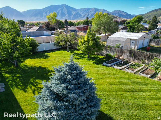 475 South 300 East Payson, UT 84651 - Photo 12 of 12 Expansive green lawn with mature trees and raised garden beds