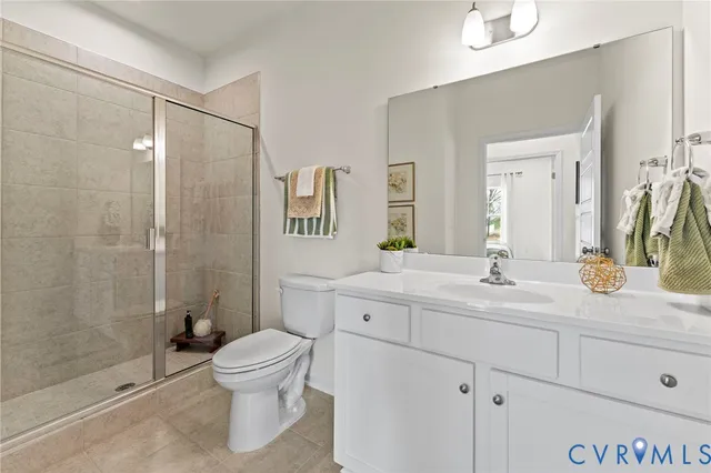 a bathroom with a toilet a sink and shower