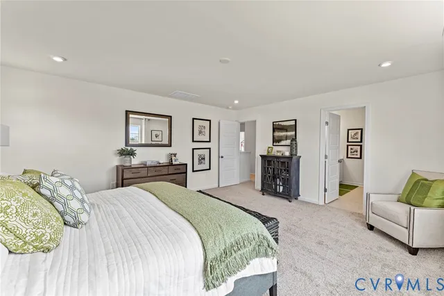 a bedroom with a large bed and a couch