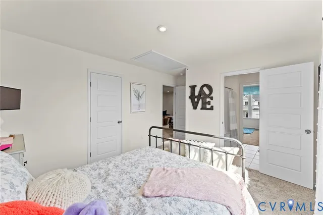 a bedroom with a bed a couch and a dresser in it