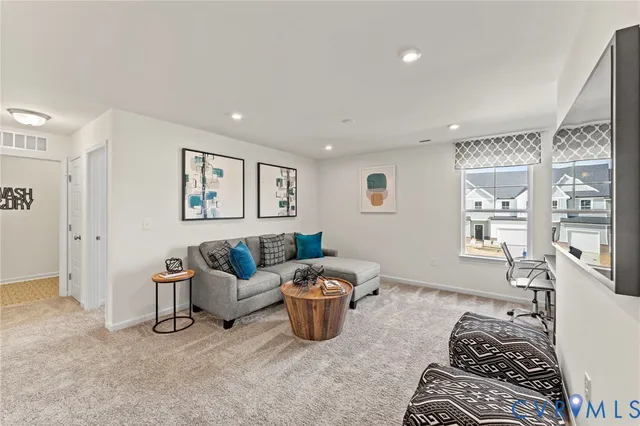 a living room with furniture a air conditioner vent and a window