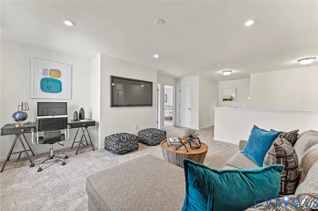 a bedroom with furniture a bed and a flat screen tv