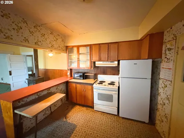 a kitchen with a refrigerator sink stove and cabinets