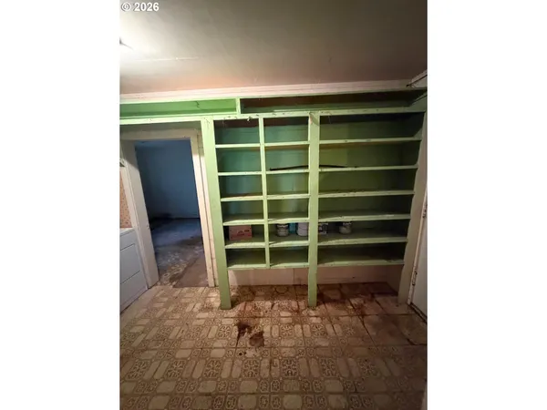 a view of an empty room with a fireplace