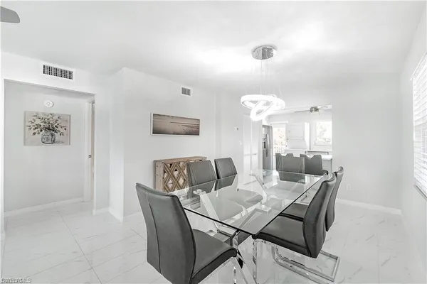 a view of a dining room with furniture and chandelier