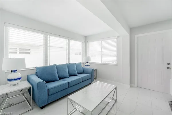 a living room with furniture and windows