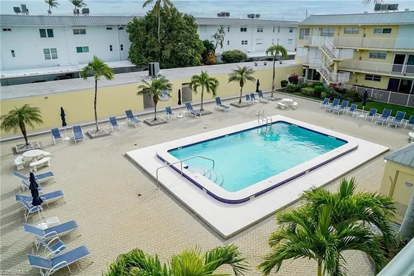 a view of a swimming pool with outdoor seating