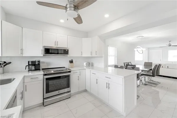 a kitchen with cabinets appliances and a counter top space