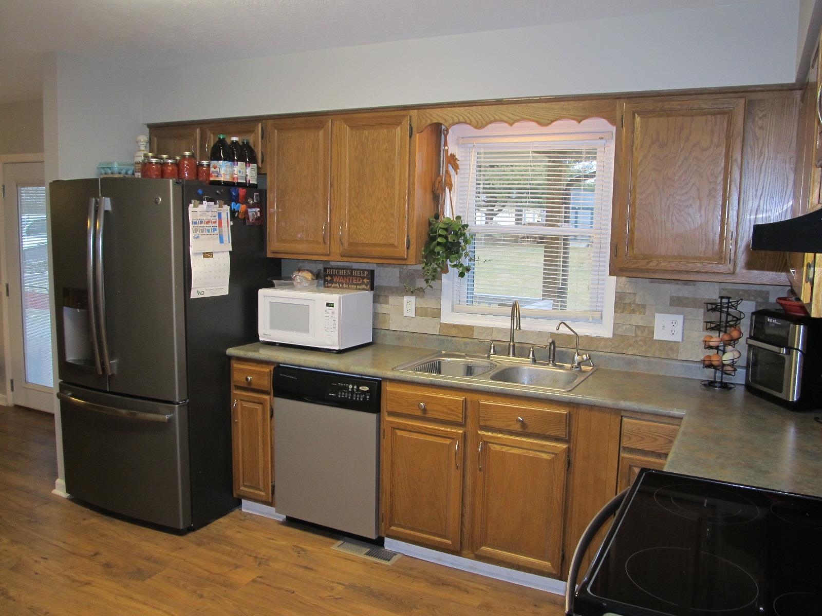 2118 Knightly Mill Road Fort Defiance, VA 24437 - Photo 20 of 49 a kitchen with a refrigerator sink and cabinets