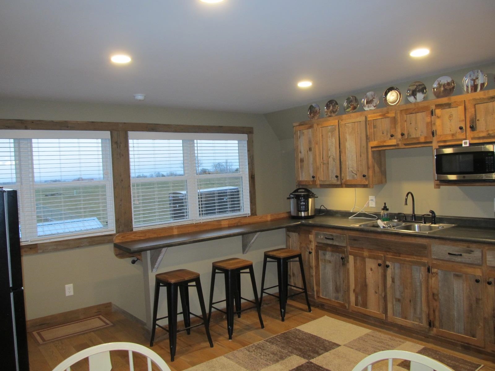 2118 Knightly Mill Road Fort Defiance, VA 24437 - Photo 37 of 49 a kitchen with stainless steel appliances granite countertop a sink and a large window