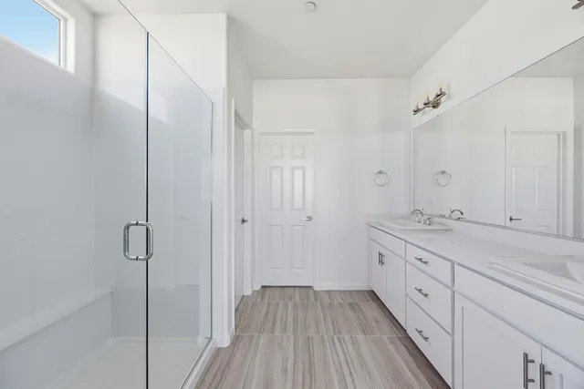 a spacious bathroom with a granite countertop sink a toilet and shower