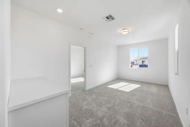 a view of an empty room and a window