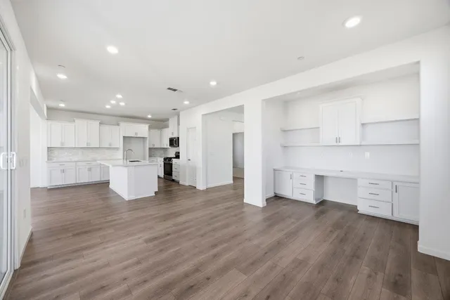 a view of kitchen view wooden floor and windows
