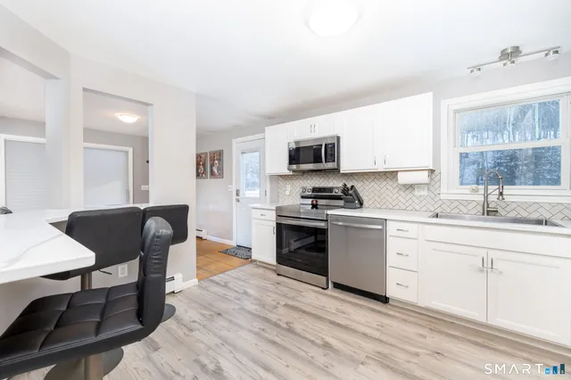 a kitchen with a sink cabinets and wooden floor