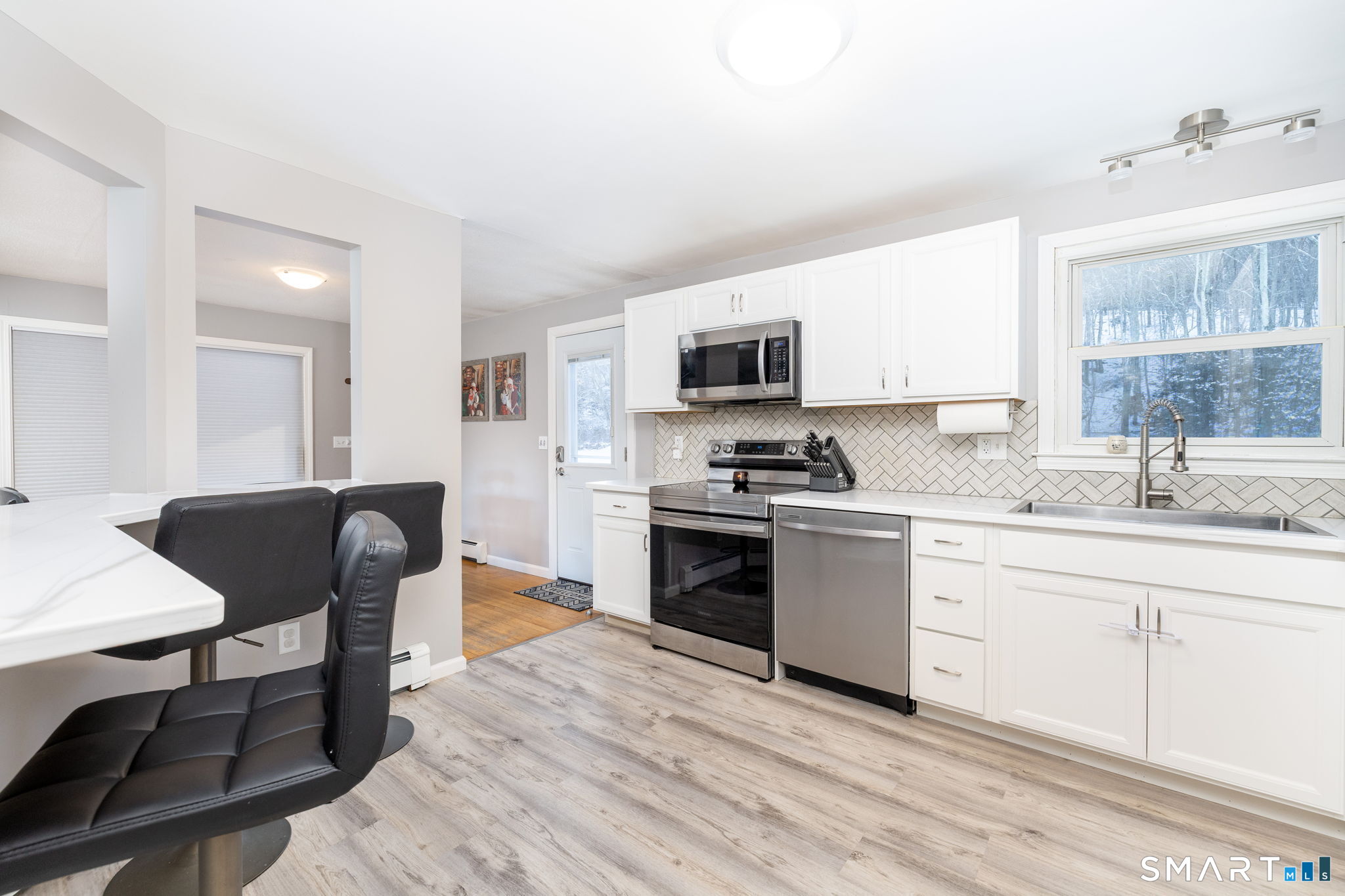 134 Massapeag Side Road Montville, CT 06382 - Photo 15 of 33 a kitchen with a sink cabinets and wooden floor