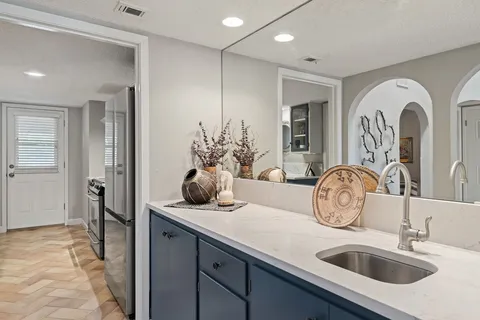 a kitchen with stainless steel appliances granite countertop a sink and cabinets