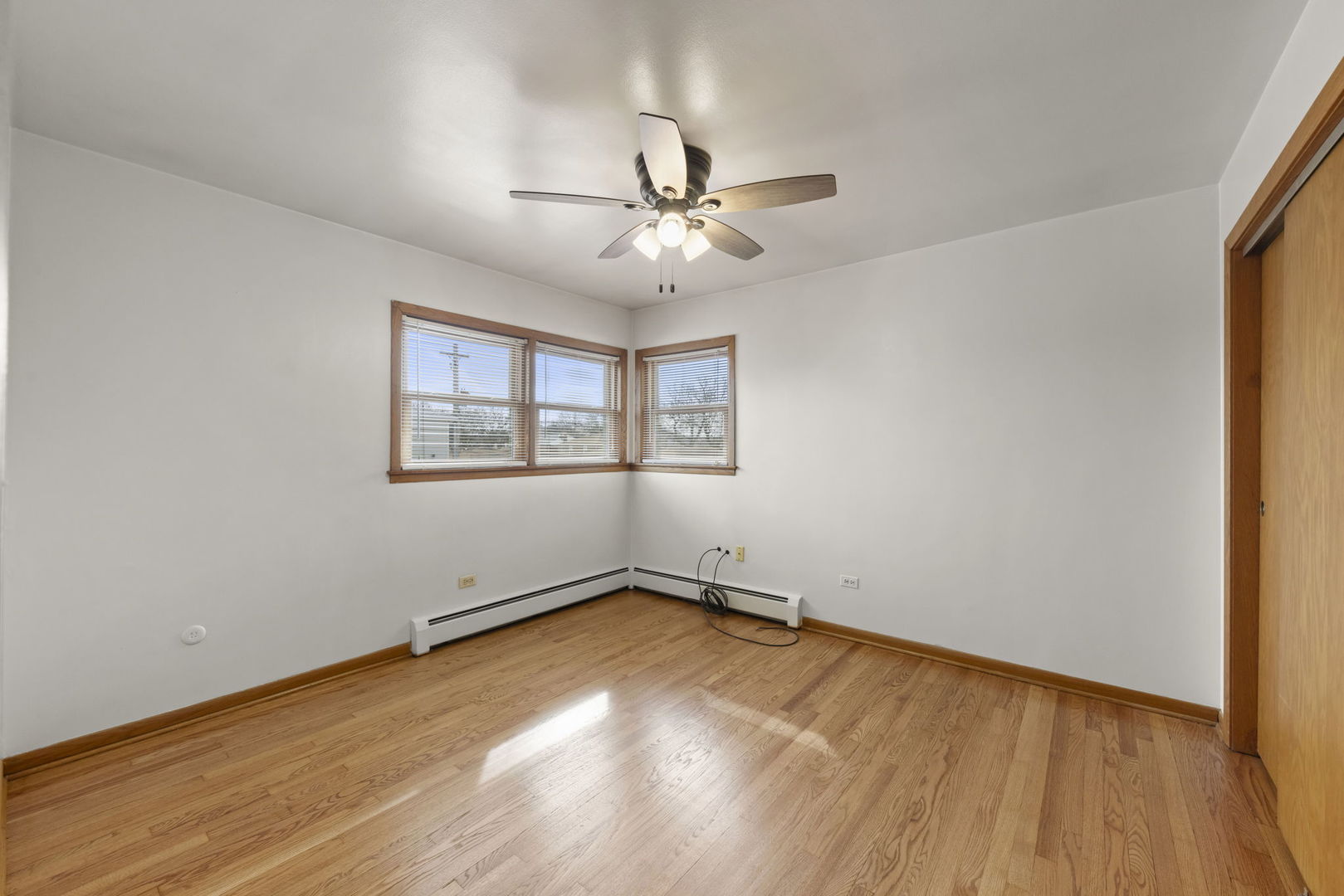 6401 West 52nd Street, Unit 2 Chicago, IL 60638 - Photo 11 of 18 wooden floor in an empty room with a window