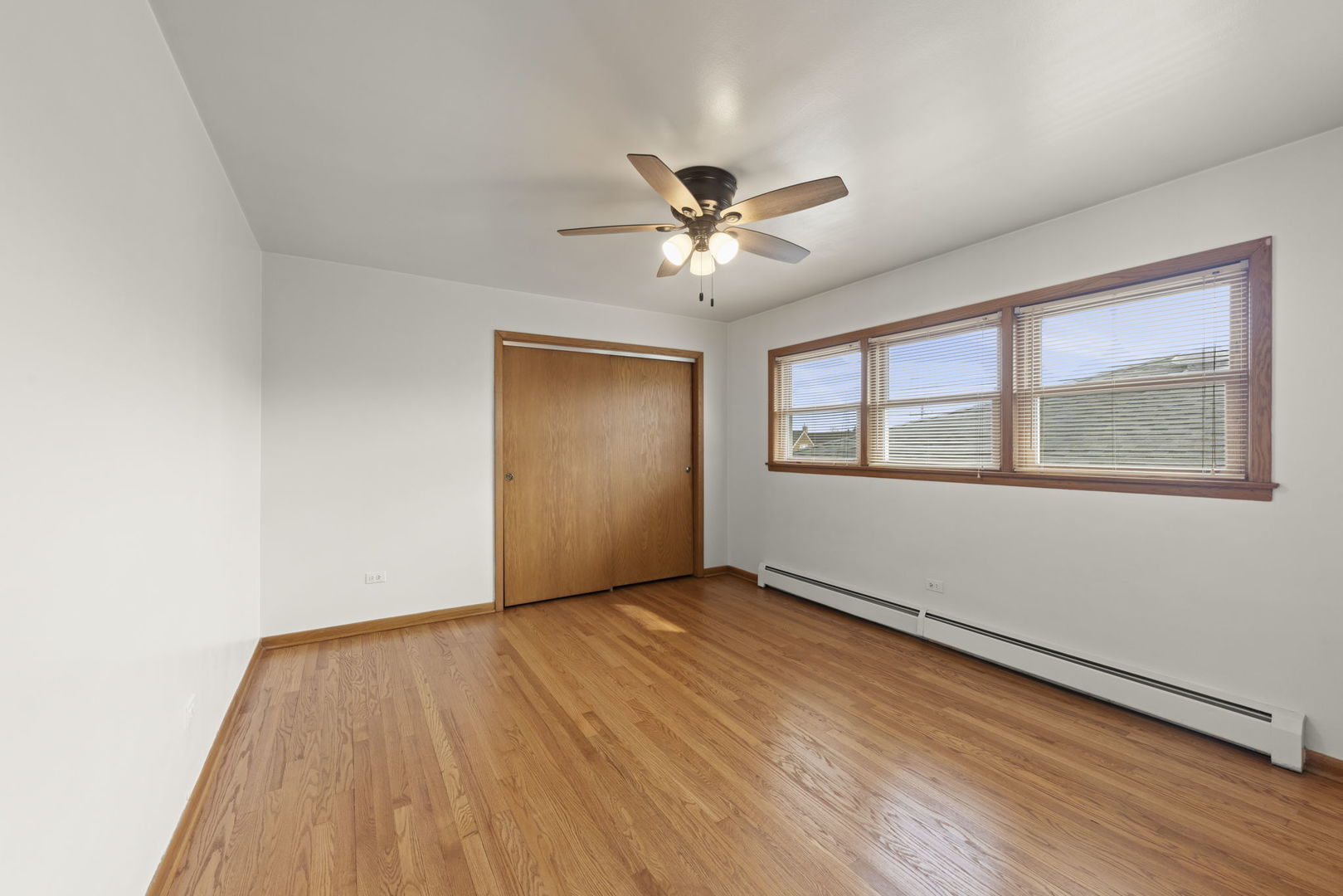6401 West 52nd Street, Unit 2 Chicago, IL 60638 - Photo 13 of 18 a view of an empty room with window and chandelier fan