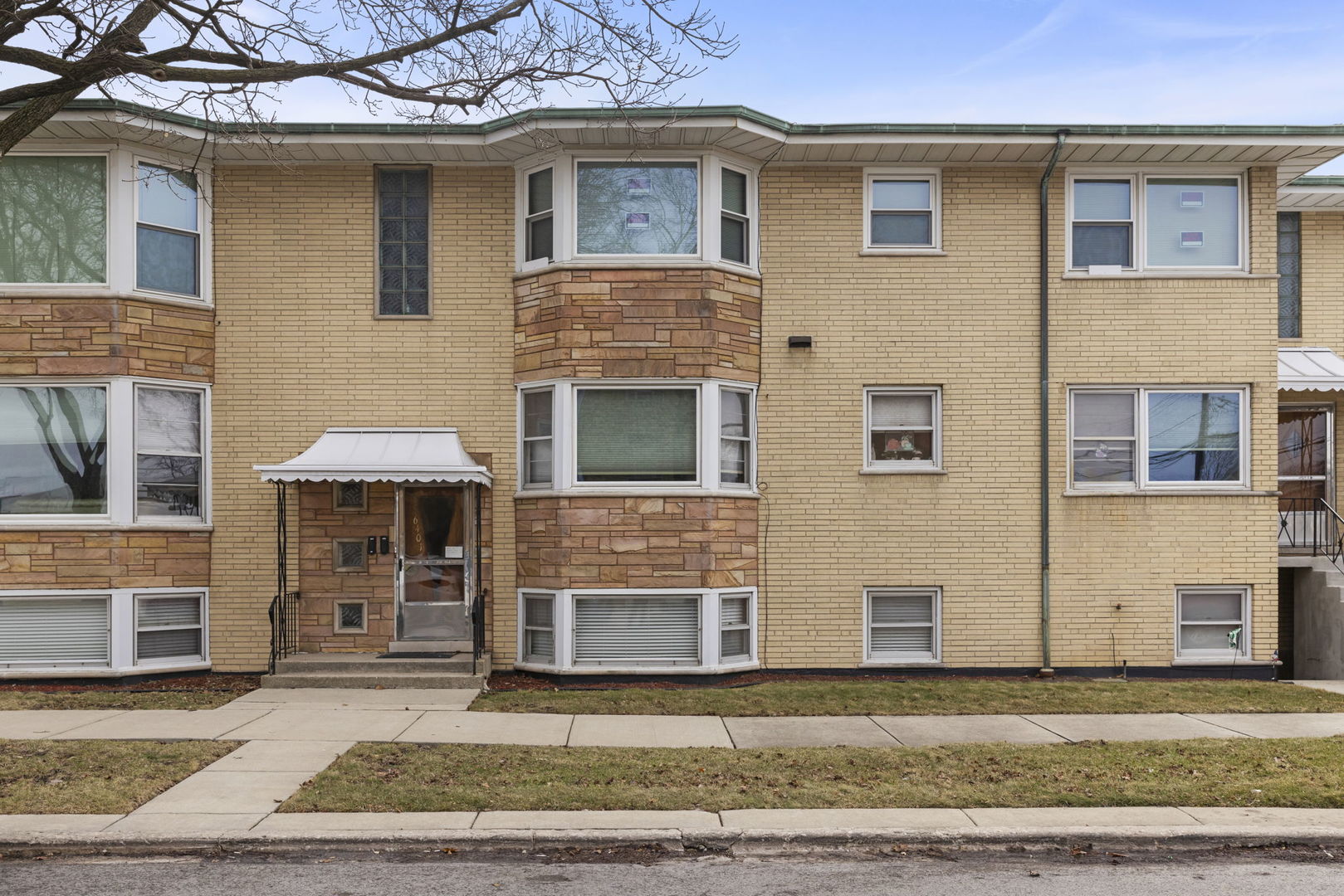 6401 West 52nd Street, Unit 2 Chicago, IL 60638 - Photo 17 of 18 a front view of a house with a yard and garage
