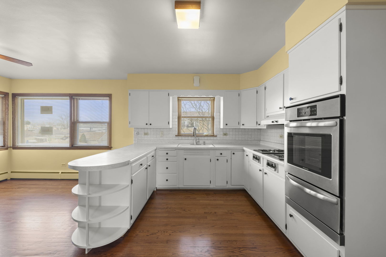 6401 West 52nd Street, Unit 2 Chicago, IL 60638 - Photo 3 of 18 a large kitchen with stainless steel appliances granite countertop a stove and a sink