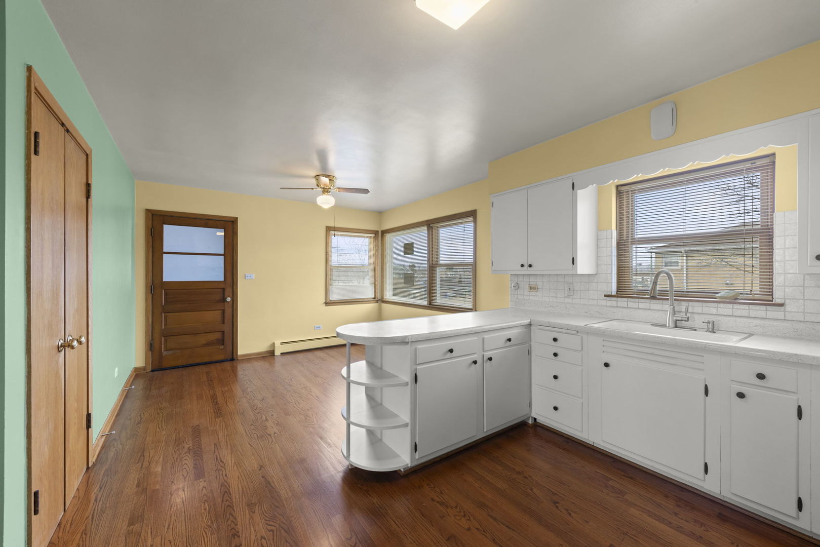 6401 West 52nd Street, Unit 2 Chicago, IL 60638 - Photo 5 of 18 a view of a large kitchen with wooden floor and two windows