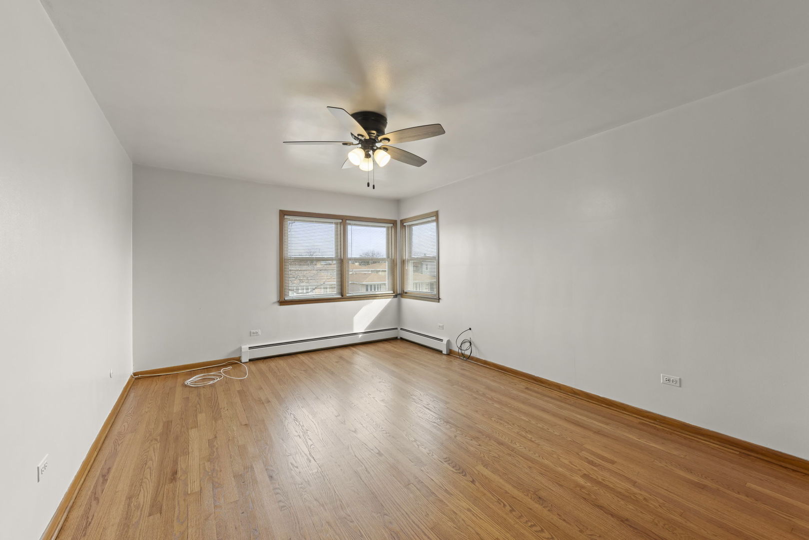 6401 West 52nd Street, Unit 2 Chicago, IL 60638 - Photo 9 of 18 wooden floor in an empty room with a window