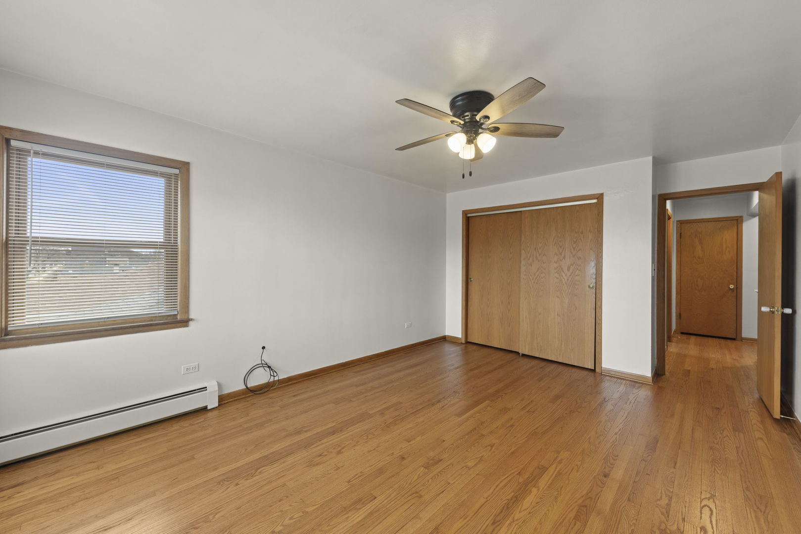 6401 West 52nd Street, Unit 2 Chicago, IL 60638 - Photo 10 of 18 a view of an empty room with window and wooden floor