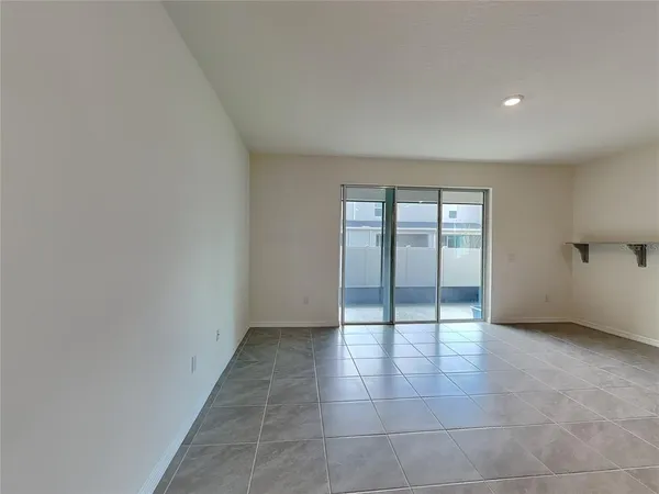 a view of an empty room with glass door