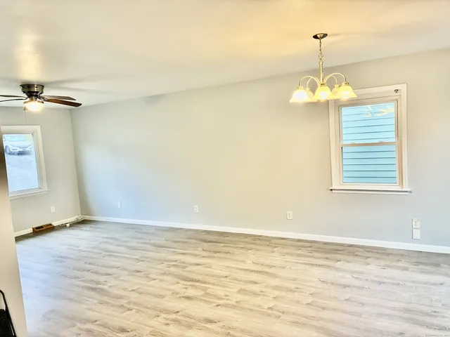 a view of living room with furniture and wooden floor