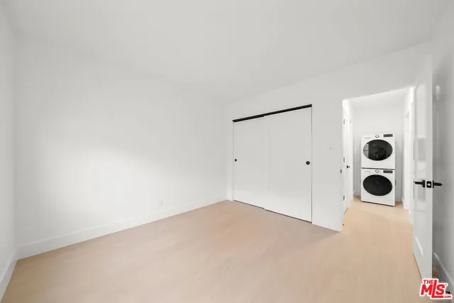 an empty room with windows and door