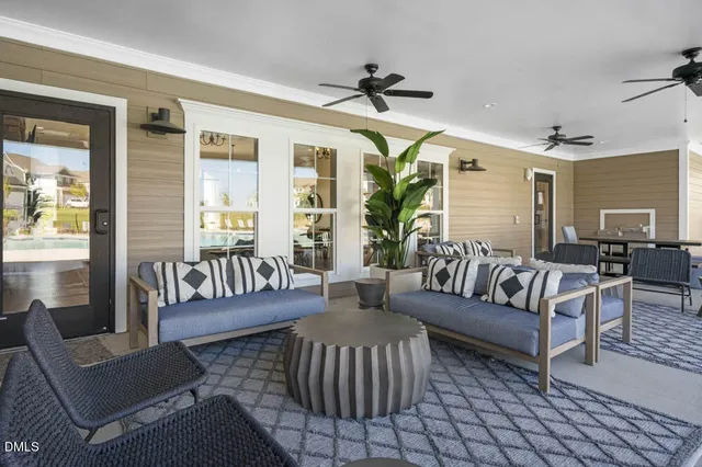 a living room with furniture a chandelier and a fireplace