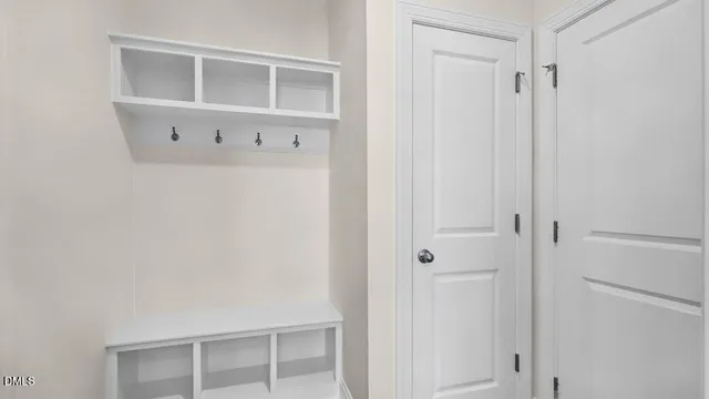 a view of kitchen with kitchen island white cabinets and wooden floor
