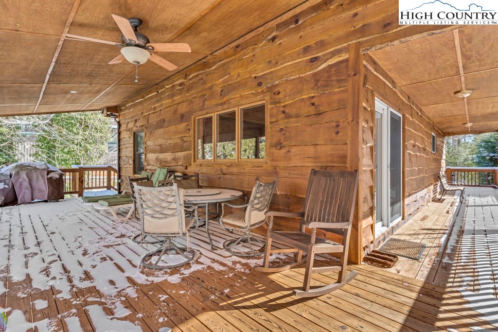 173 Spring Brook Road Newland, NC 28657 - Photo 35 of 39 a view of a patio with table and chairs and wooden floor