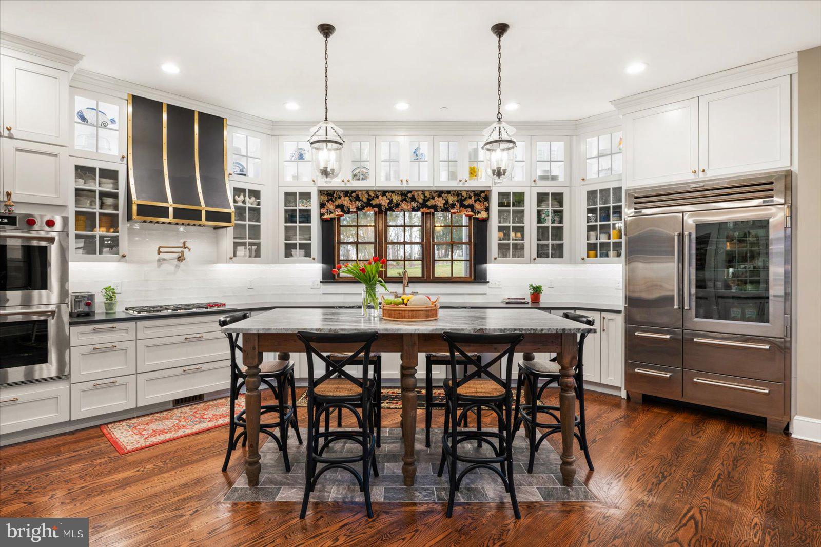 828 Federal Hill Road Street, MD 21154 - Photo 23 of 73 a kitchen with stainless steel appliances granite countertop a kitchen island a stove and a dining table with wooden floor