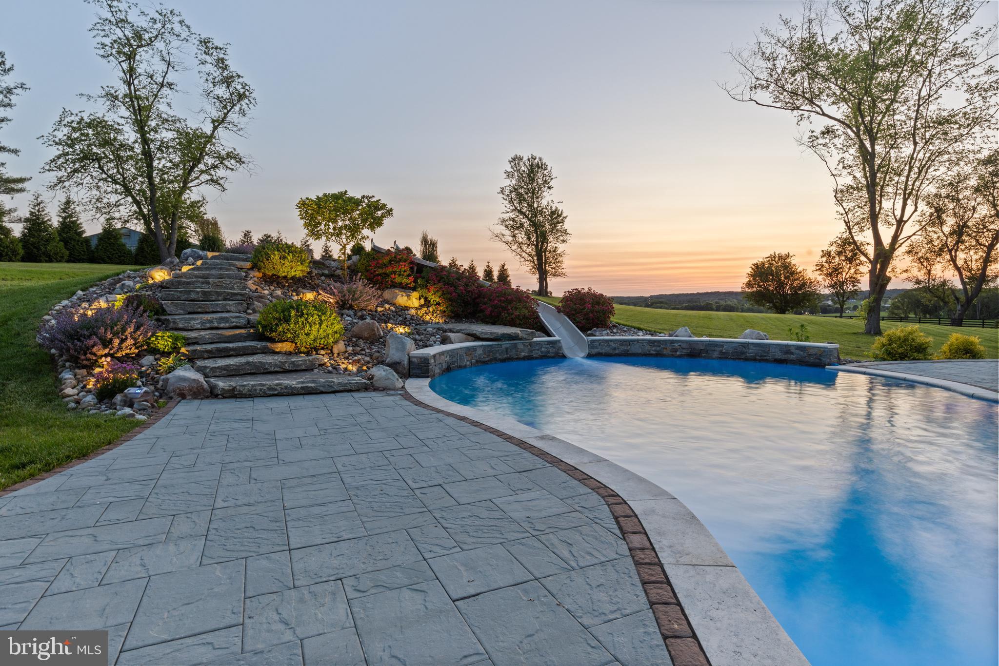 828 Federal Hill Road Street, MD 21154 - Photo 5 of 73 a view of a lake with a bench and trees