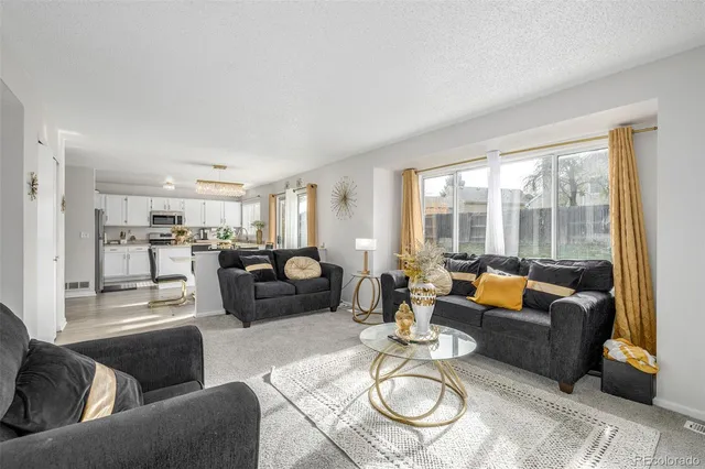 a living room with furniture and a table