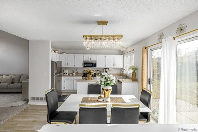 a dining room with furniture and a large window