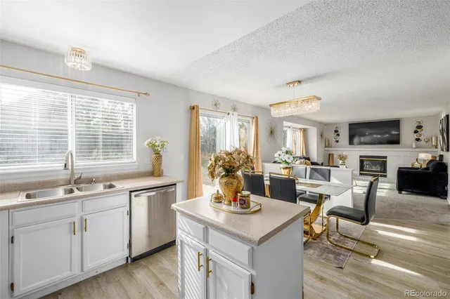 a view of a kitchen area with furniture and wooden floor