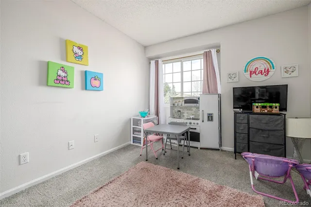 a living room with furniture cabinets and a window