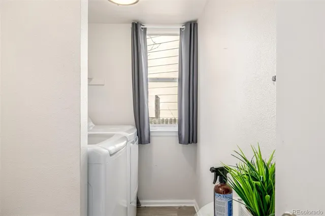 a front view of house with yard and trees around