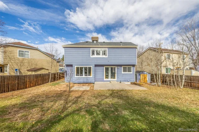 a view of a house with a yard covered with snow
