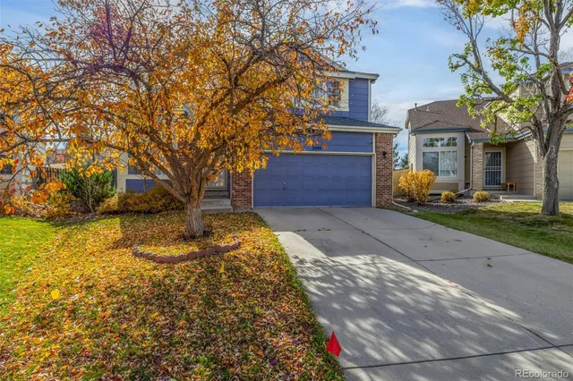 a front view of a house with a yard garage and outdoor seating