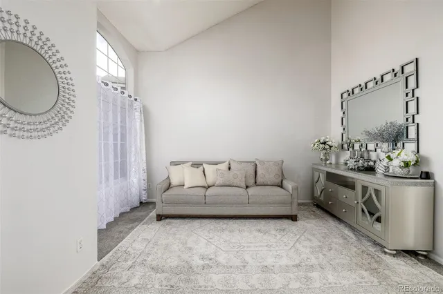 a living room with furniture a mirror and a sink