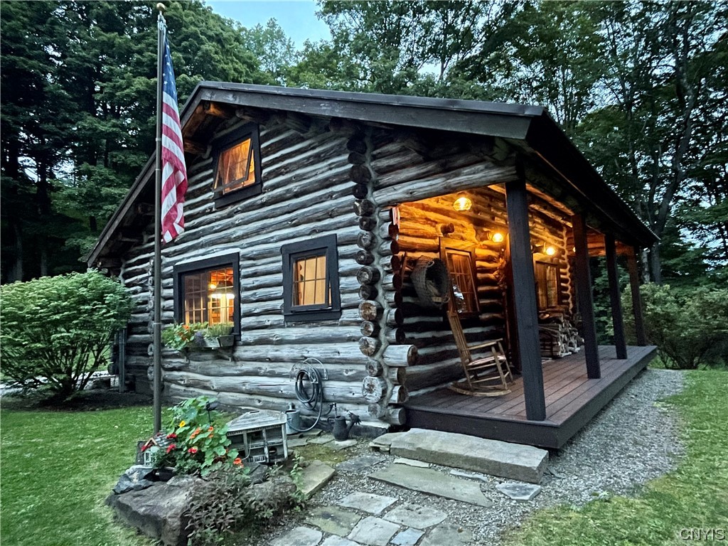 7807 Bonney Hill Road Hamilton, NY 13346 - Photo 9 of 50 Front porch of main cabin at dusk