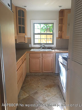 215 Beverly Road West Palm Beach, FL 33405 - Photo 4 of 7 a kitchen with stainless steel appliances granite countertop a stove a sink and a refrigerator