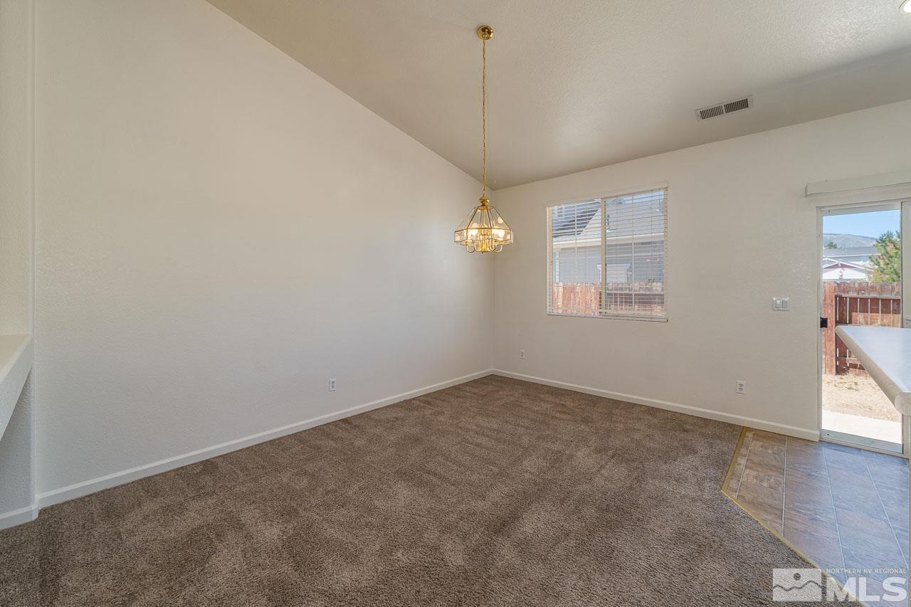 9025 Andraste Way Reno, NV 89506 - Photo 12 of 31 an empty room with windows and ceiling fan