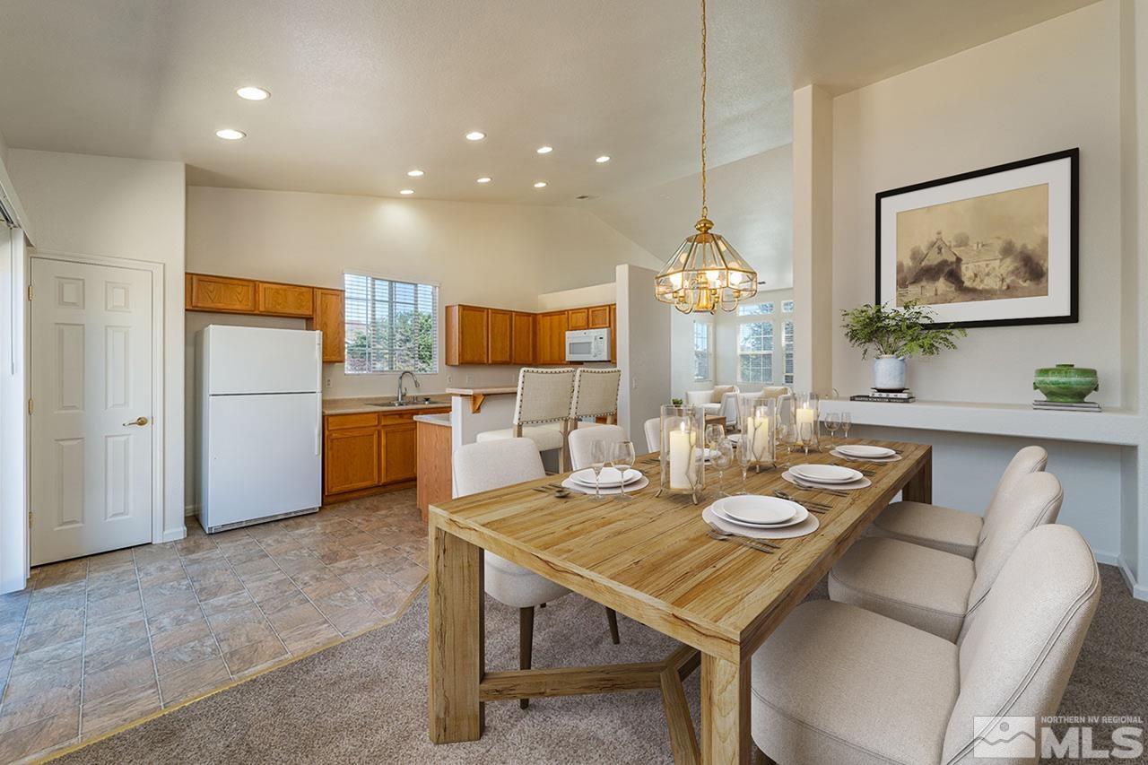 9025 Andraste Way Reno, NV 89506 - Photo 13 of 31 a view of a dining room with furniture and chandelier